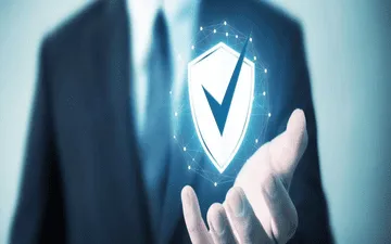 O que é seguro cyber risk? Na imagem, dono de empresa segurando, metaforicamente, um símbolo que retrata a importância do seguro de riscos cibernéticos para empresas.